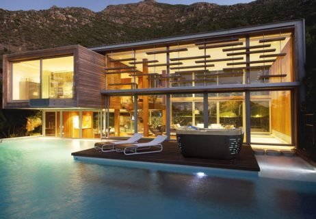 Swimming pool and modern house at night