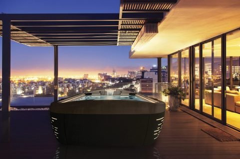 Illuminated luxury house and patio overlooking city